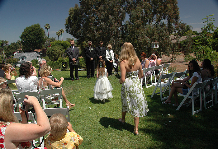 Elizabeth and Larissa walk toward the waiting groom.