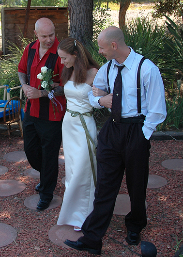 Barb is escorted up the aisle by her brothers Derrick and Ray.